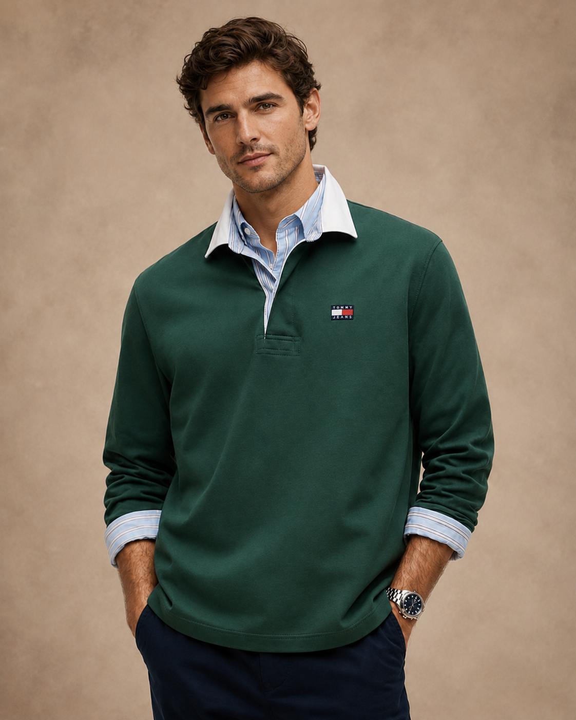 Model wearing a green heritage rugby shirt layered over a striped shirt
