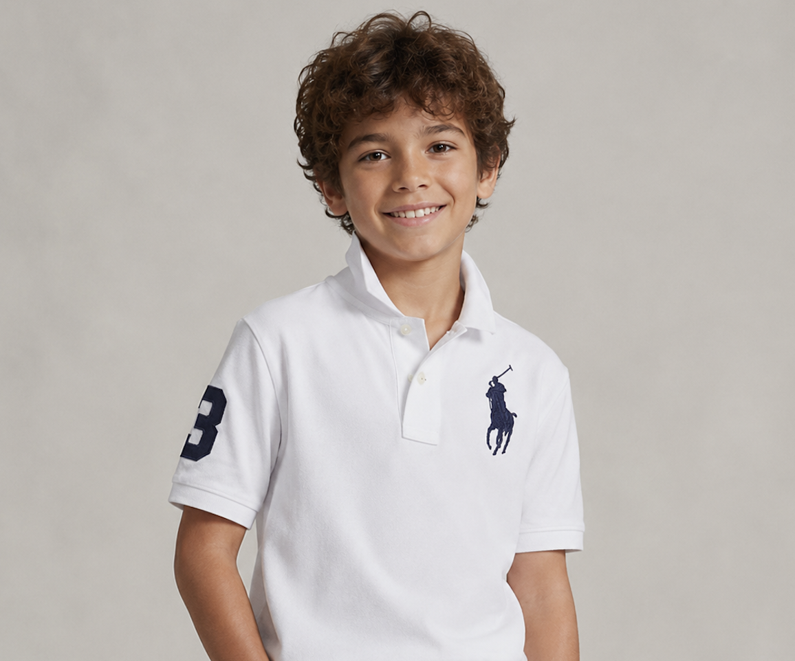 Child wearing a classic white polo with dark denim
