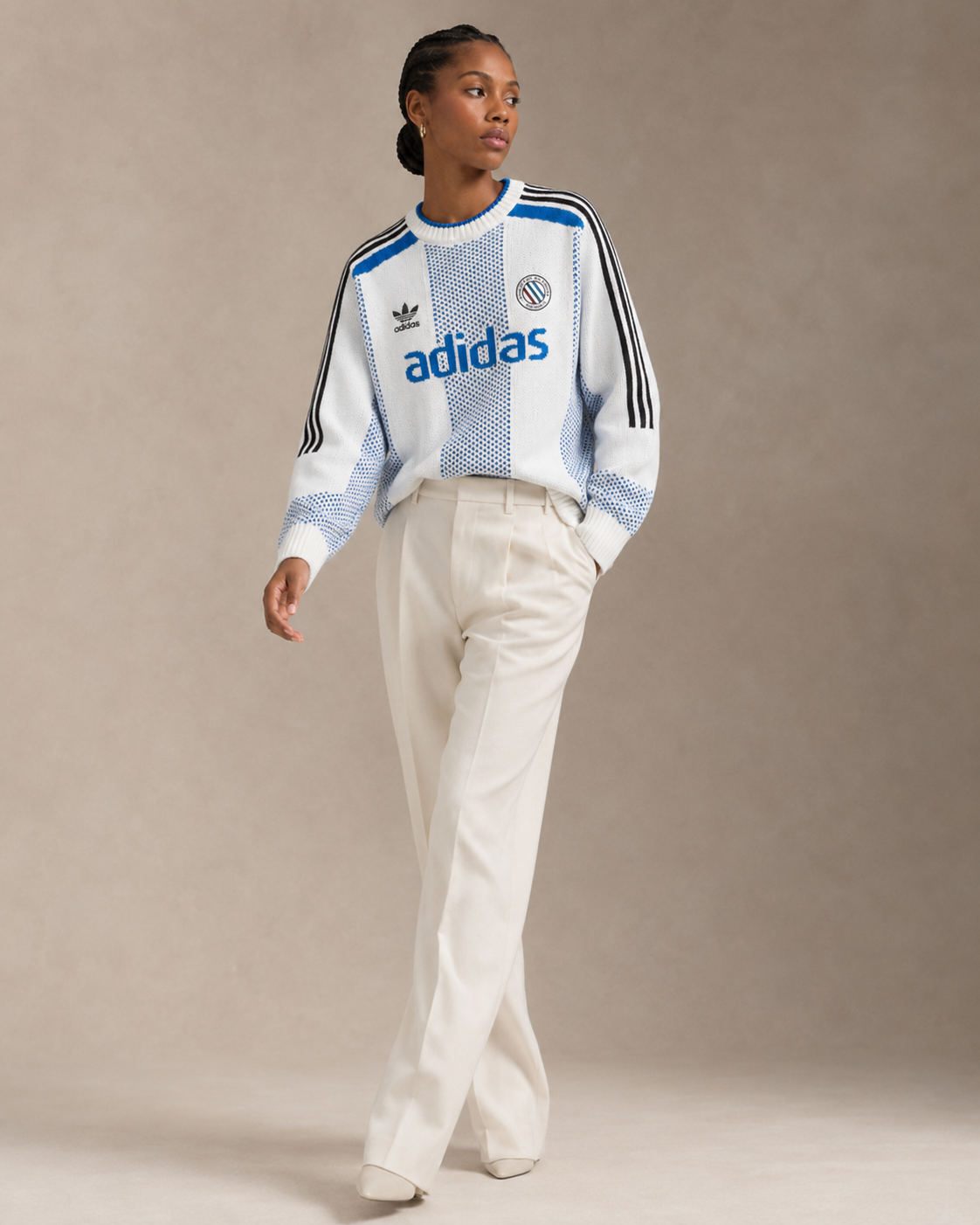 Model wearing a vintage Adidas knit with white trousers